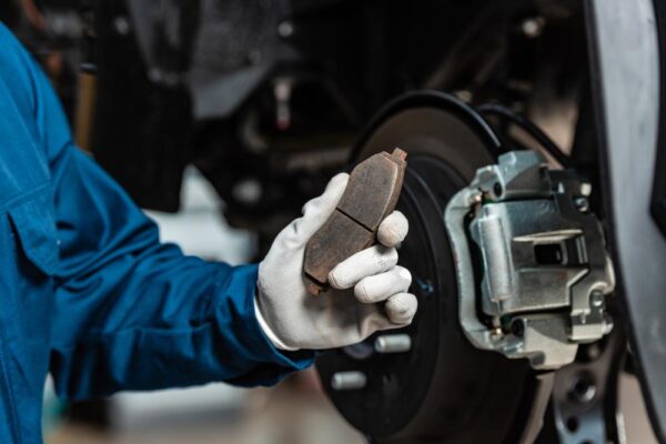 worn brake pads and damaged brake rotors needing replacement